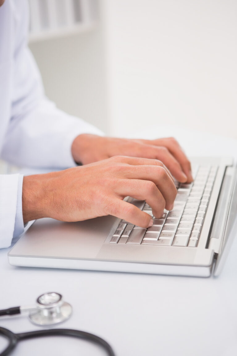 doctor using laptop in medical office